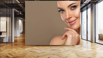 Beautiful young woman with clean fresh skin touching her face . Girl facial  treatment   . Cosmetology , beauty  and spa . Female  model, care concept Wall mural