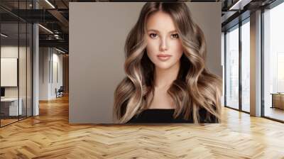 Beauty  girl with long  and   shiny wavy  Hair ,coloring and toning, shatush and balayash .  Beautiful   woman model with curly hairstyle . Wall mural