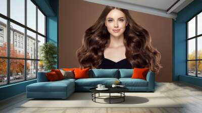 Beauty girl with long  and   shiny wavy hair .  Beautiful   woman model with curly hairstyle . Wall mural