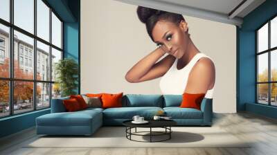 Beauty portrait of african american black  woman with clean healthy skin . Life style and cosmetic. Smiling beautiful afro girl.Curly afro hair  tied in a hairstyle bun Wall mural