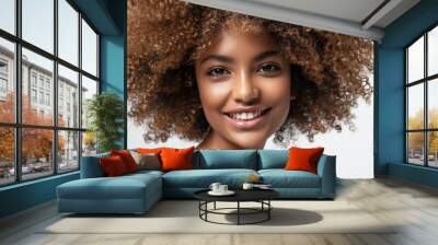 Beauty portrait of african american girl with clean healthy skin on beige background. Smiling dreamy beautiful black woman.Curly hair in afro style Wall mural