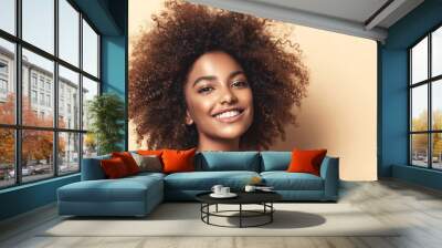 Beauty portrait of african american woman with clean healthy skin on beige background. Smiling beautiful afro girl.Curly black hair. Black teen girl Wall mural