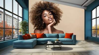 Beauty portrait of african american woman with clean healthy skin on beige background. Smiling dreamy beautiful afro girl.Curly black hair Wall mural