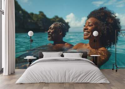 African American old couple in love swim in tropical sea Wall mural