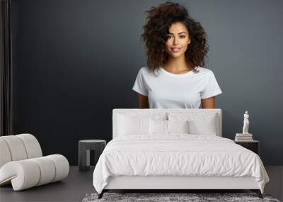 Beautiful young dark-haired brunette woman in white t-shirt isolated on gray background Wall mural