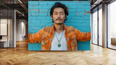 Confident man in casual attire against vibrant blue brick wall Wall mural