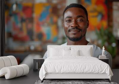 Confident young African American man smiling in a modern colorful office Wall mural