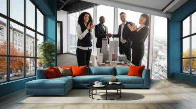 Multiethnic businesspeople real estate, agents developers handshake and applauding after successful deal of city district urban planning project good team work. Business partnership meeting concept Wall mural