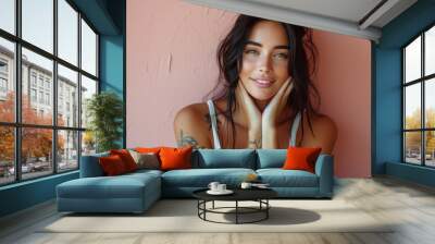 Natural beauty smiling against pink wall in casual attire Wall mural