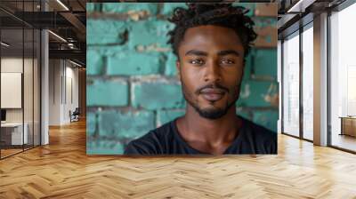 Portrait of confident young man against rustic teal wall background Wall mural