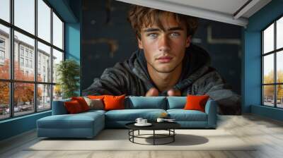 Young man with intense gaze in casual attire portrait Wall mural