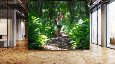 Defocused forest trail with a woman watching the birds. Wall mural