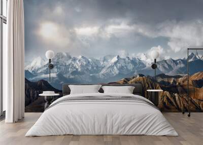 Panoramic view of the scenic landscape of snowy mountains and dramatic clouds Wall mural