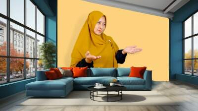 South east Asian Indonesian woman female hijab olive color smiling greeting hand gesture. Wall mural