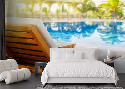 Lounger with sun hat and swimming pool in luxury resort Wall mural