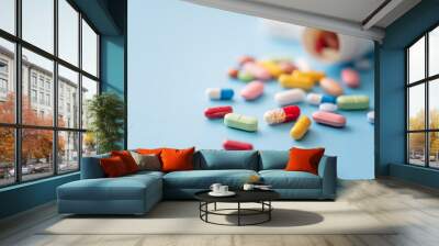 Multicolored Pills scattered from white plastic medicine container Wall mural