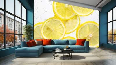 Slices of lemon in water with air bubbles on white Wall mural