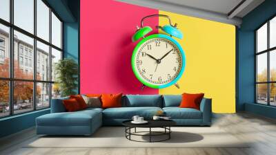 Trendy Multicolored alarm clock on bright colorful background. Top view. Flat lay Wall mural