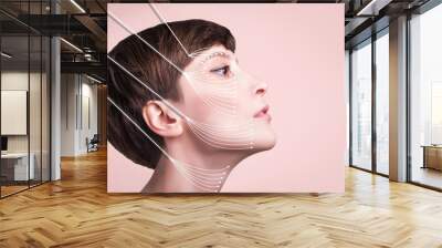 Young female with clean fresh skin. Beautiful woman. Female face and neck. Portrait of young caucasian woman at studio isolated on pastel. Short haircut, long neck, perfect skin. Lifting by gold Wall mural