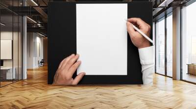 a blank sheet of paper and a businessman's hands on a black table, a white shirt and a wrist watch, a top view-a template for any text or inscription Wall mural