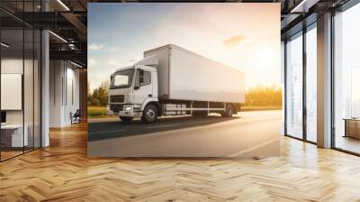 A white truck is driving on the road against the background of a summer landscape Wall mural