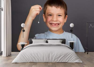 boy with lost tooth on thread Wall mural