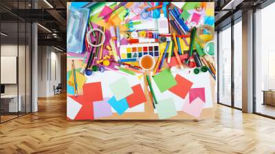 Child drawing top view. Artwork workplace with creative accessories. Flat lay art tools for painting. Wall mural