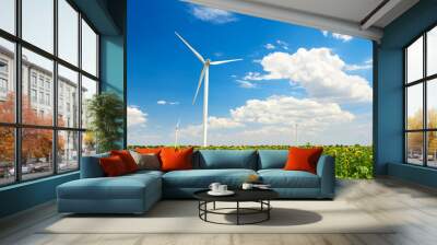 The wind generator in sunflower field. Beautiful landscape with bright cloudy sky. Eco energy concept. Wall mural