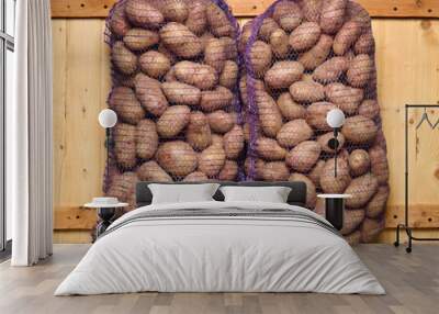 two bags of potatoes on a wooden background Wall mural