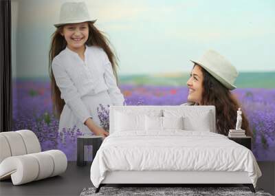 young woman and girl are in the lavender field, beautiful summer landscape with red poppy flowers Wall mural