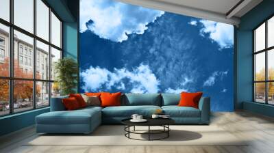 White fluffy clouds in a bright blue sky on a sunny day. Wall mural