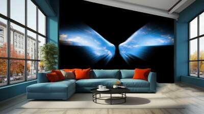 Angel wings isolated on black background and blue sky is visible Wall mural