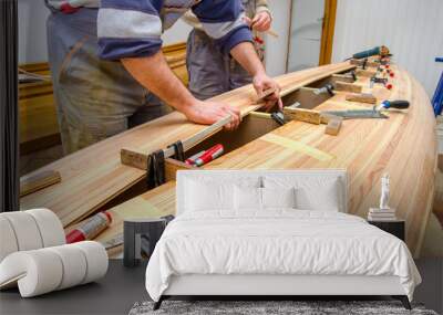 Carpenters making wooden boat in carpenter workshop Wall mural