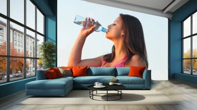 Young woman drinking water in summer Wall mural