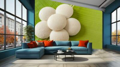 Indian idly served as a flower - Fresh steamed Indian Idly (Idli / rice cake) arranged decoratively as a flower on traditional banana leaf. Natural light used. Wall mural