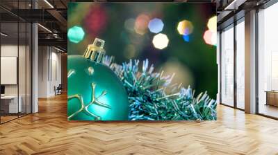 A large glass bowl with a pattern of snowflakes. In the background, blurred lights of a Christmas tree. Boke. Christmas toys in the Christmas tinsel. Wall mural