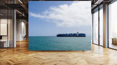 Container ship or container ship loaded with containers freight on the Indian ocean waves near the Zanzibar seaport. Container maritime shipping and transcontinental business concept photo. Wall mural