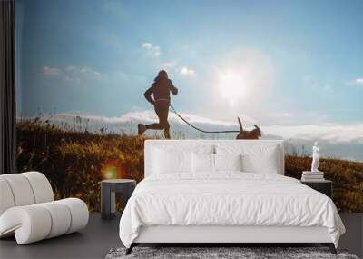 Man runing with his beagle dog at sunny morning. Healthy lifestyle and Canicross exercises jogging concept image. Wall mural