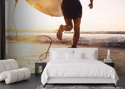 Man surfer run in ocean with surfboard. Active vacation, health lifestyle and sport concept image Wall mural