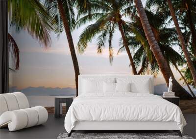 Young woman sitting in hammock swinging on the exotic island sand beach at sunrise time Wall mural