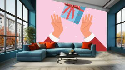 hand holding  gift box, greeting card concept. Merry Christmas and Happy New Year banner, surprise greeting card. Wall mural