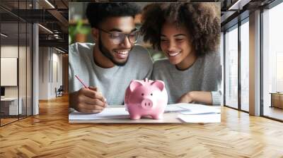 Family budget management: A young couple planning their savings together with a pink piggy bank on the table Wall mural