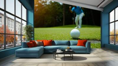 Golfer action to win after long putting golf ball in to the hole. Wall mural