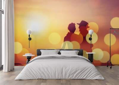 Silhouette sunset : Senior business man and his wife walking on the beach sunset ,Silhouette romance after retire happy life concept scene marriage anniversary over sunset luxury and happiness moment Wall mural