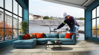 Engineer working to inspect equipment in rooftop solar power plant, solar panel maintenance installation view Wall mural