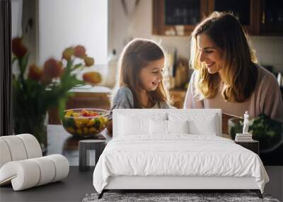 Mother and daughter in aprons are cooking vegetarian food at the kitchen table. Wall mural