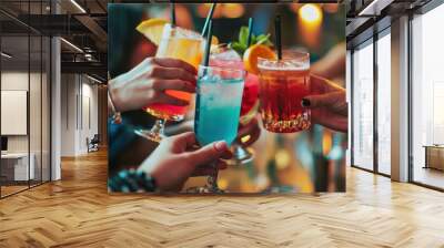 People hold hands and drink colorful fancy drinks. Young friends having fun drinking cocktails at happy hour. Wall mural