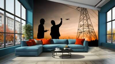 Two electrical engineers used drones to observe the planning work, producing electric power at high voltage electrodes Wall mural