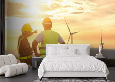 Two engineers discussed the plan for the maintenance of wind turbines. Renewable energy with wind generator by alternative energy concept in Asia Wall mural