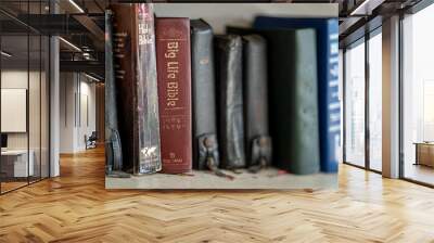 CHIANG MAI, THAILNAD - 24 JANUARY 2019 :  Numerous Holy Bibles sit in a row on wooden shelf. Bookshelf with used prayer books inside.. Wall mural